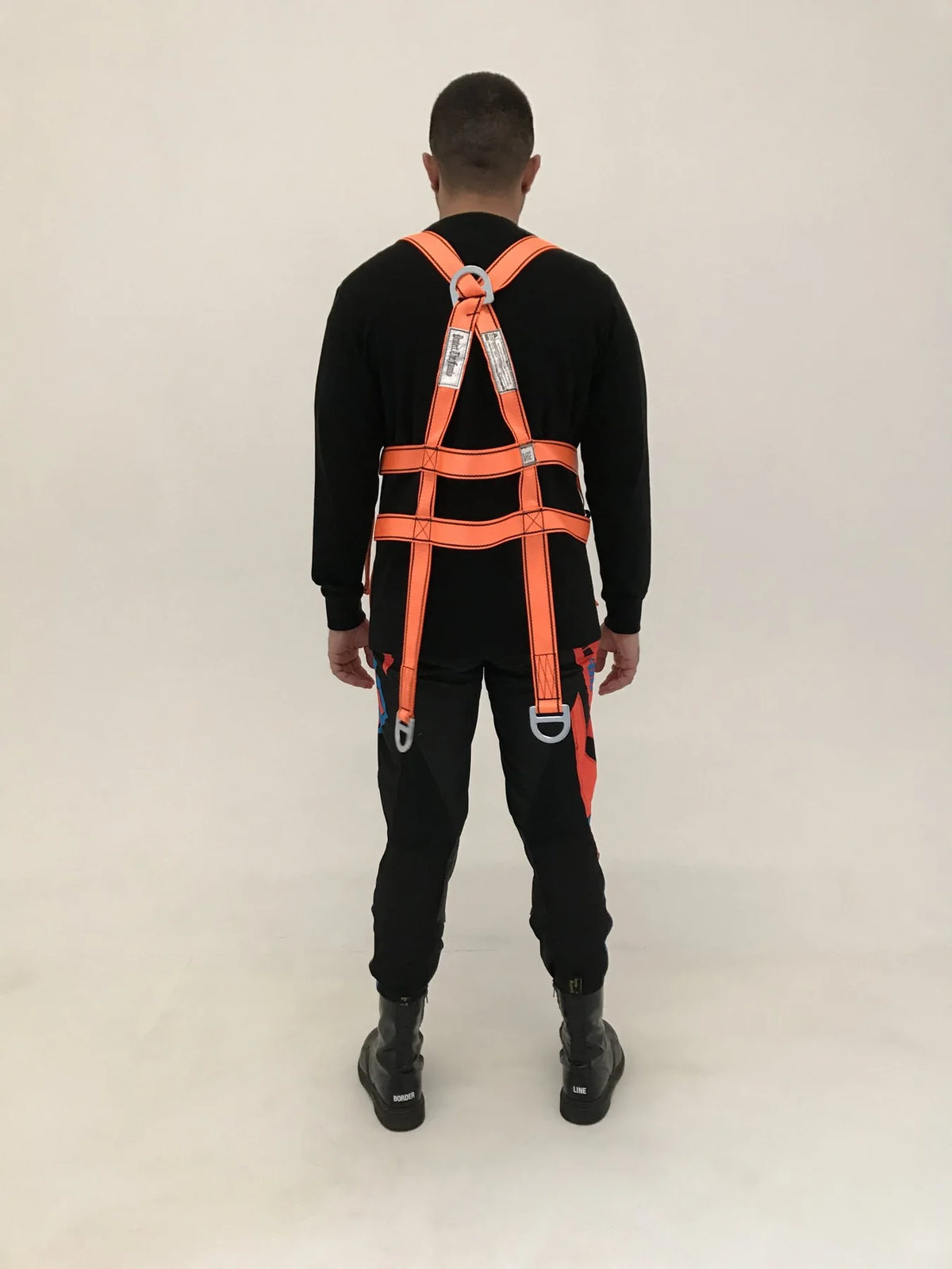 Protect The Family harness worn over a black bomber, back view, lookbook 2017