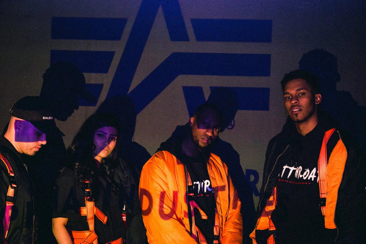 Models in Protect The Family bombers in front of the Alpha Industries logo, July 2017